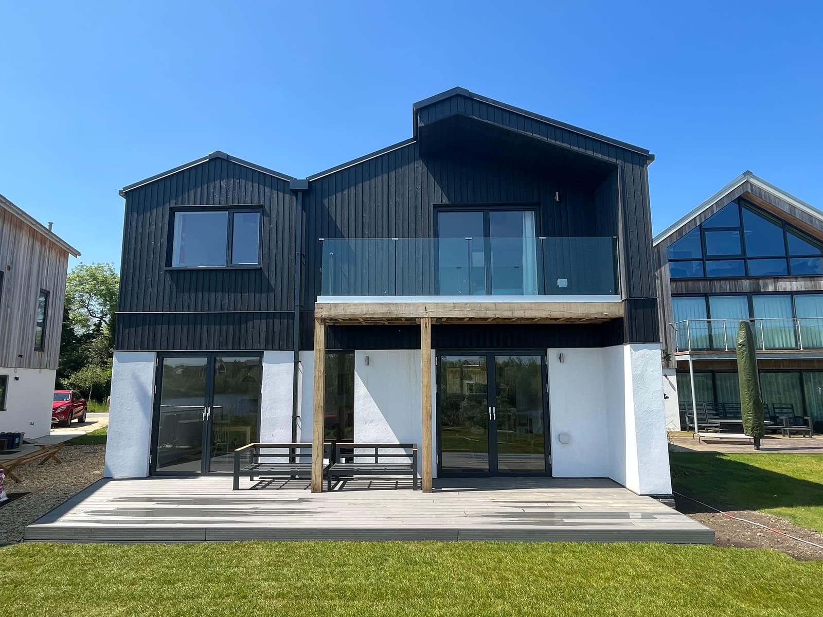 Balcony and deck on the black timber and white render elevation