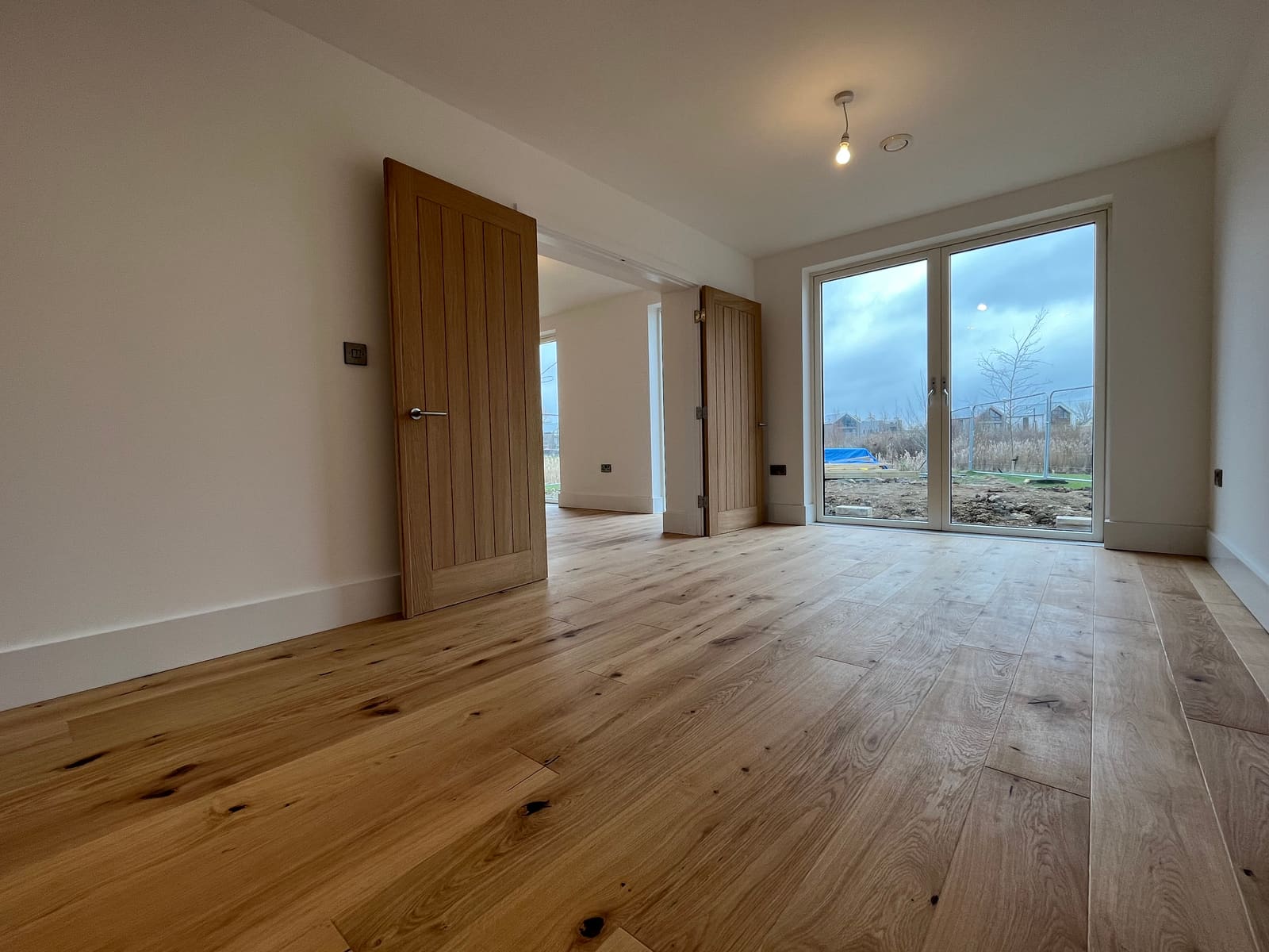 Living room with oak floor and garden doors