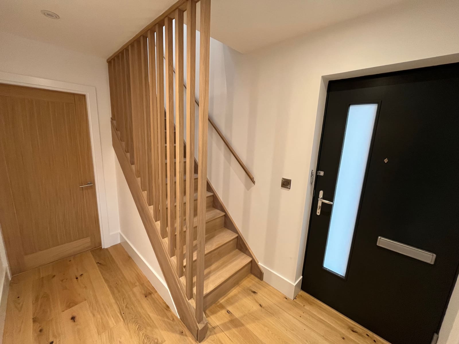 Oak staircase beside the front door