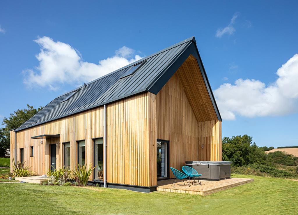 Larch clad Devon home with a standing seam roof
