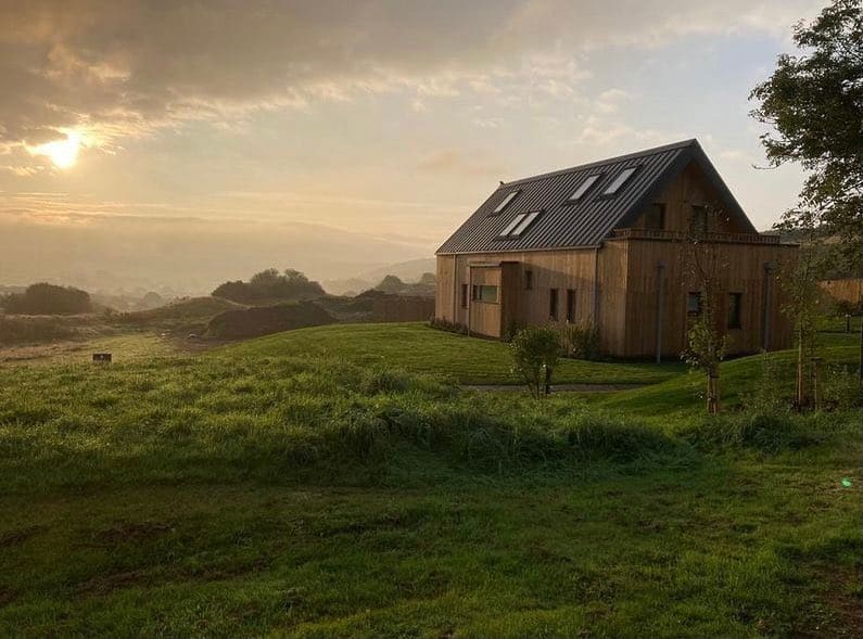 The house in its valley at sunset
