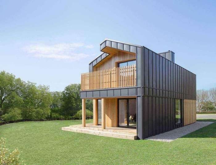 nHouse home with a timber balcony and standing seam cladding