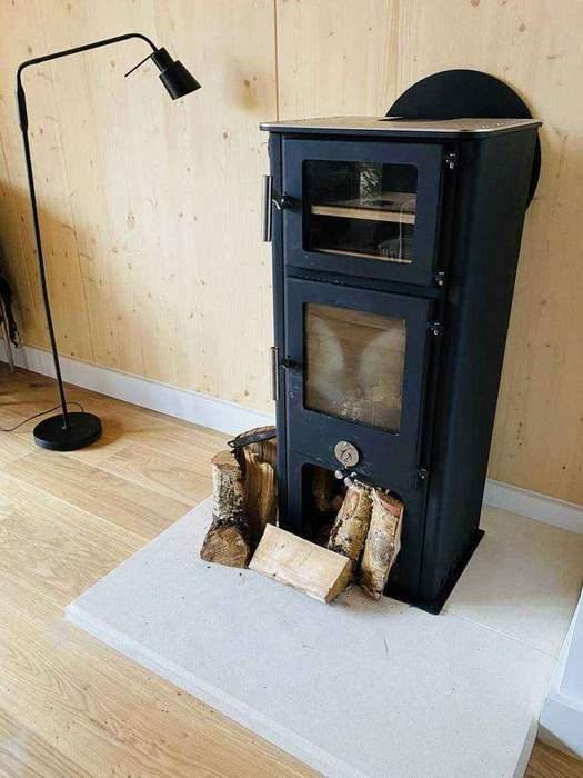 Wood burning stove on a timber wall