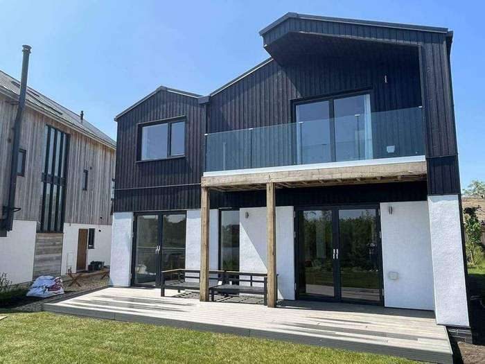 Dark clad elevation and garden