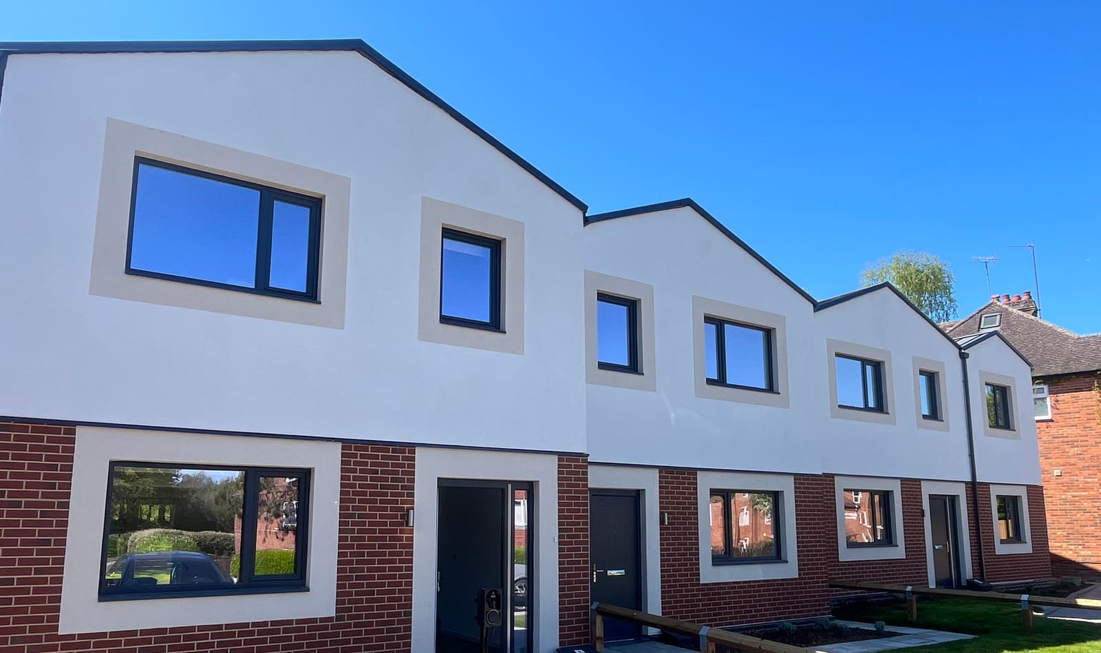 Front of the homes, white render over brick