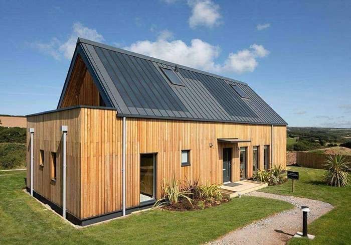 Timber clad nHouse home with standing seam roof