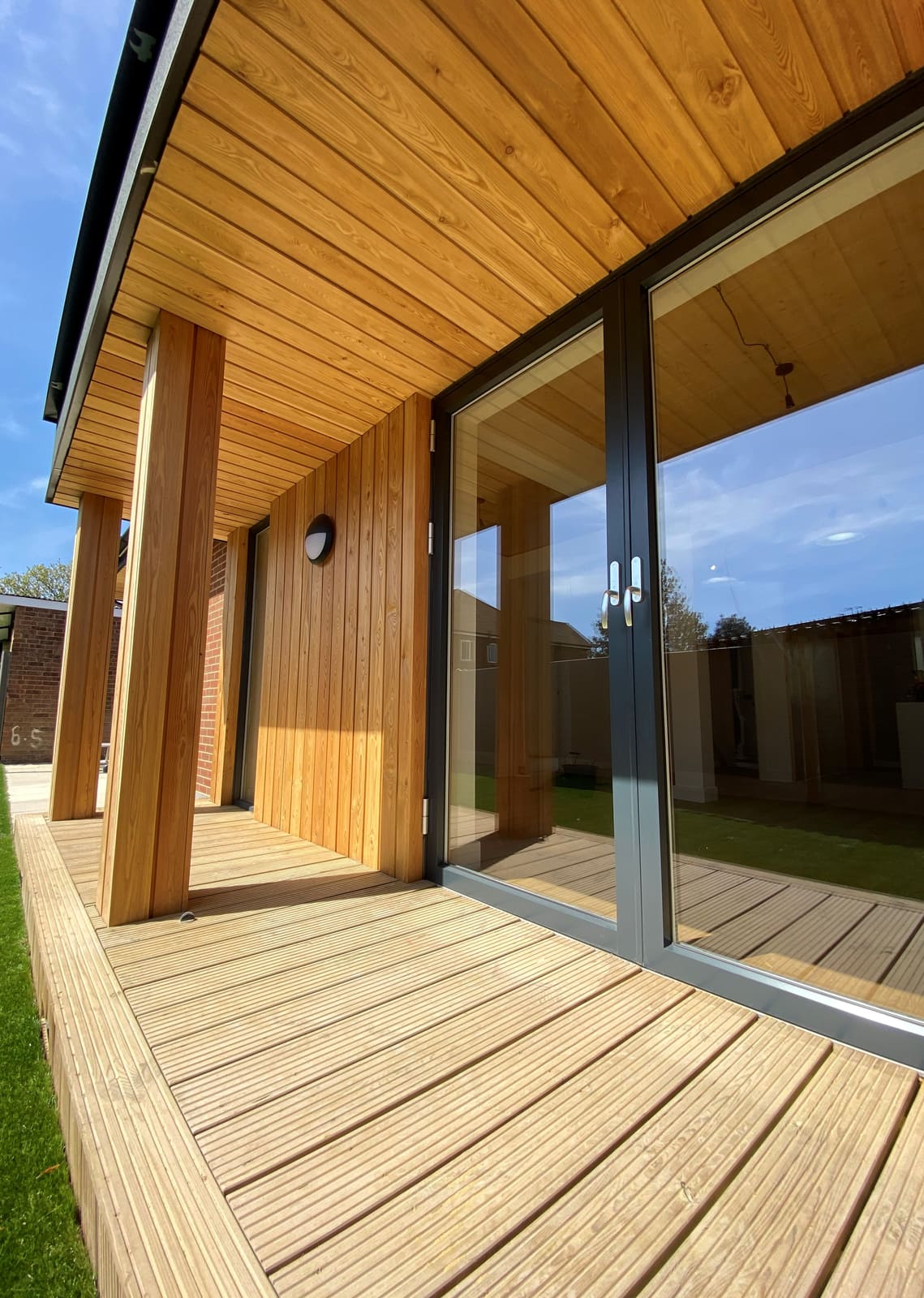 Timber deck and soffit along the glazing